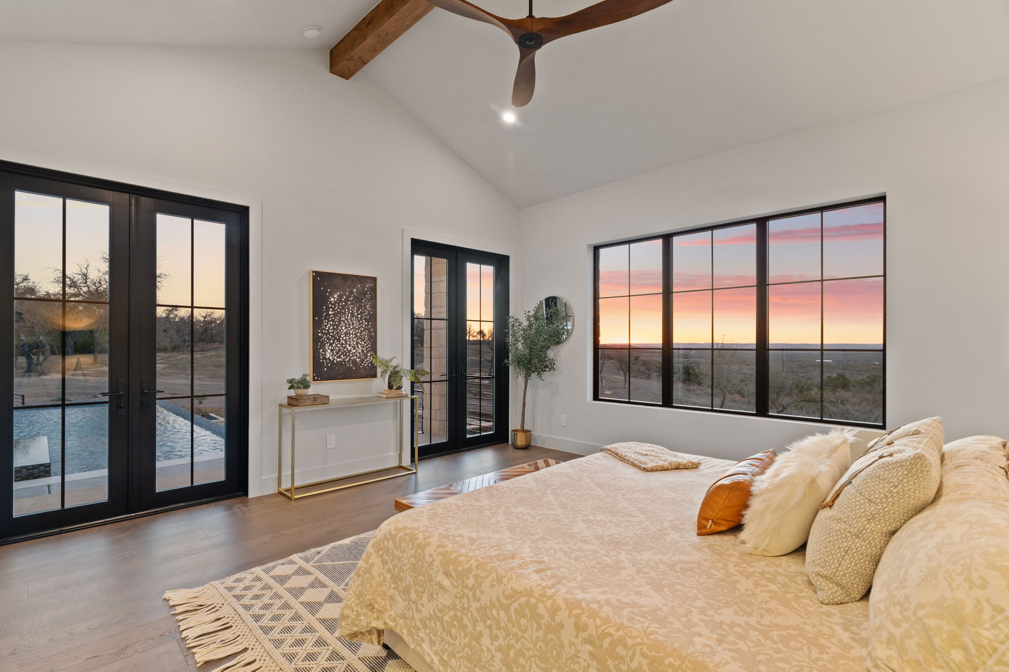 1562 Canyon Crossing View Dripping Springs, TX 78620 - Photo 15 of 40 a bedroom with a large bed and a large window