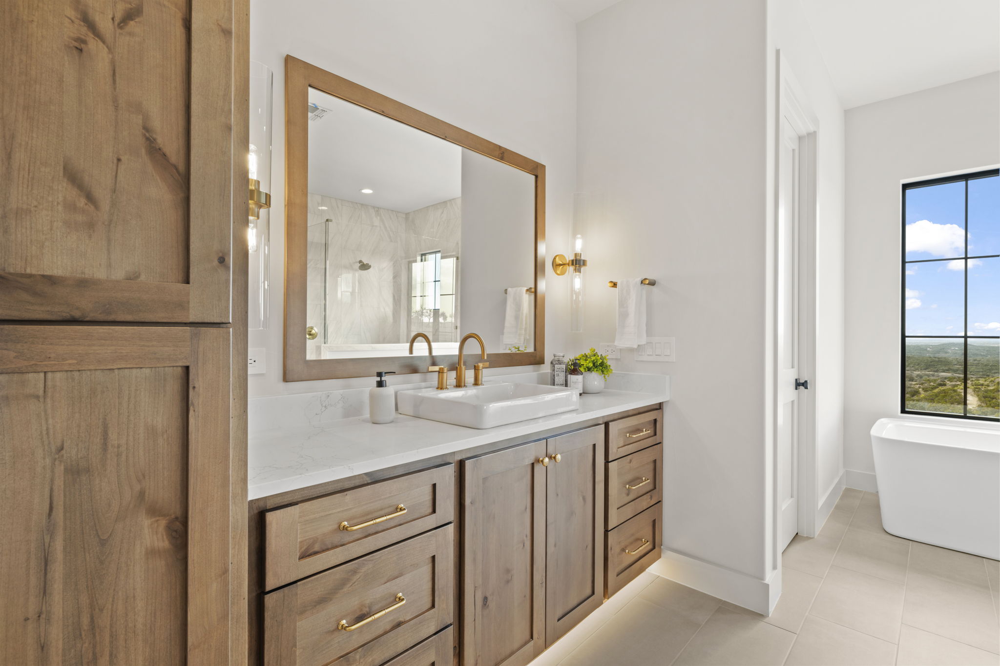 1562 Canyon Crossing View Dripping Springs, TX 78620 - Photo 16 of 40 a bathroom with a double vanity sink and a mirror