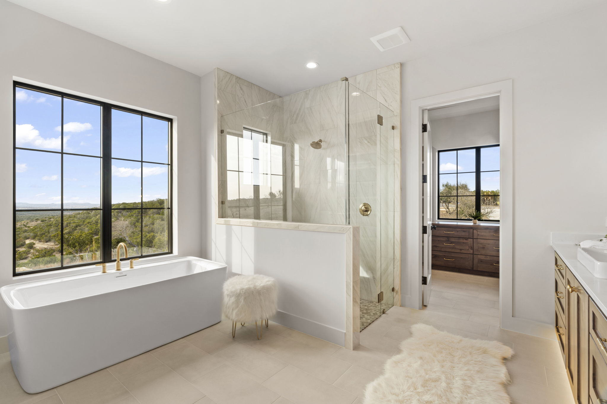1562 Canyon Crossing View Dripping Springs, TX 78620 - Photo 17 of 40 a bathroom with a tub shower and sink