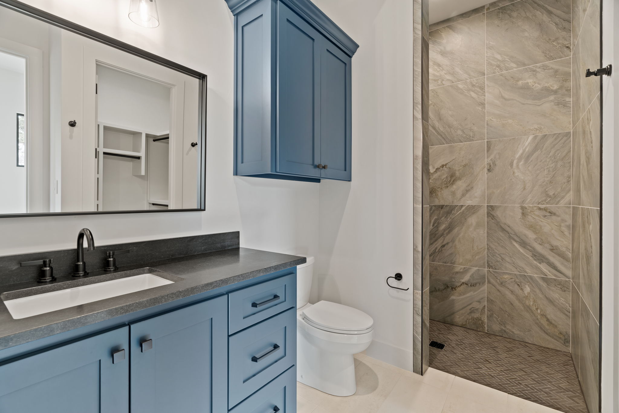1562 Canyon Crossing View Dripping Springs, TX 78620 - Photo 21 of 40 a bathroom with a granite countertop sink toilet and shower