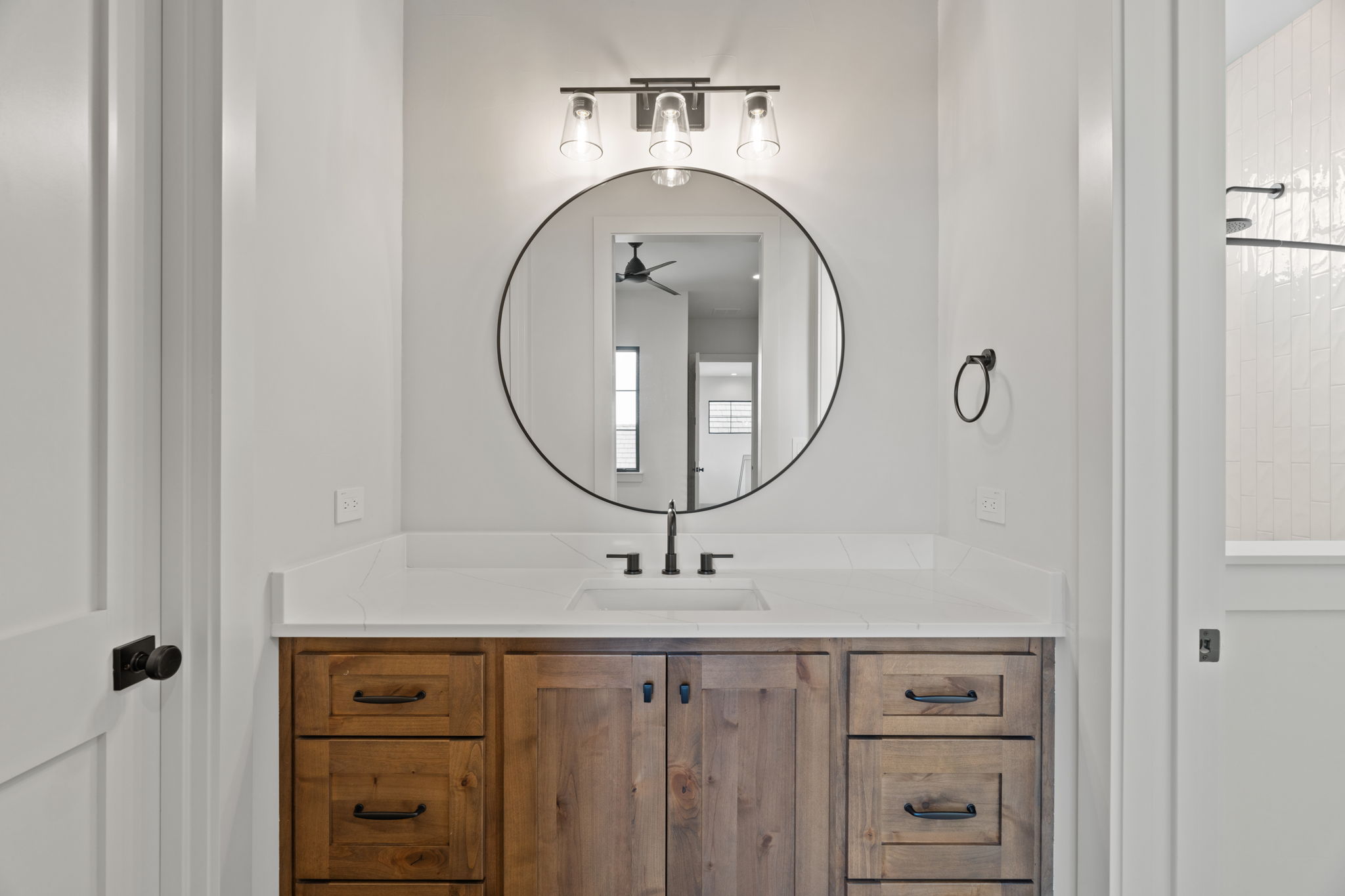 1562 Canyon Crossing View Dripping Springs, TX 78620 - Photo 28 of 40 a bathroom with a sink a mirror and a light fixture