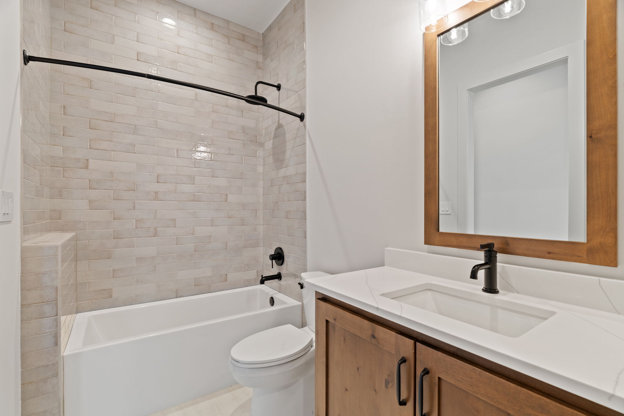 1562 Canyon Crossing View Dripping Springs, TX 78620 - Photo 32 of 40 a bathroom with a granite countertop sink a toilet and bathtub