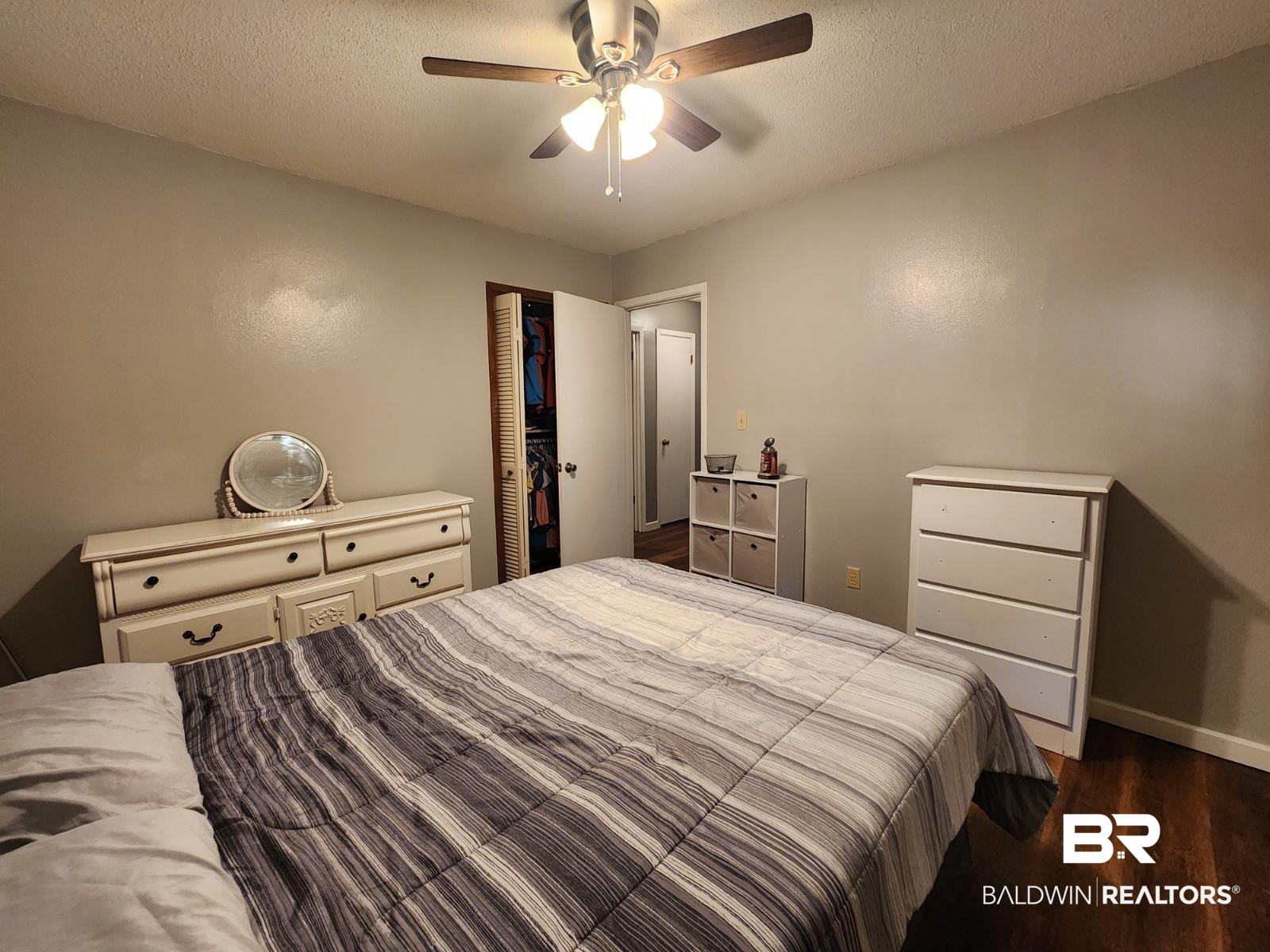 640 Horseshoe Road Brewton, AL 36426 - Photo 15 of 22 Bedroom with a textured ceiling, a closet, wood-type flooring, and ceiling fan
