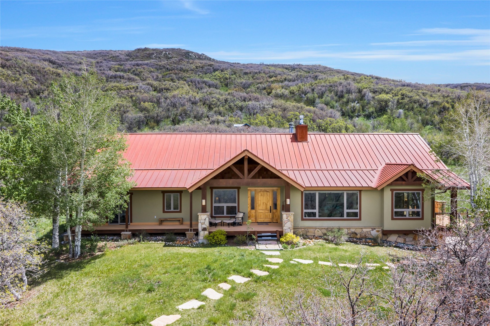 31485 Deerwood Ranch Road Steamboat Springs, CO 80487 - Photo 4 of 49 a front view of house with yard and seating area