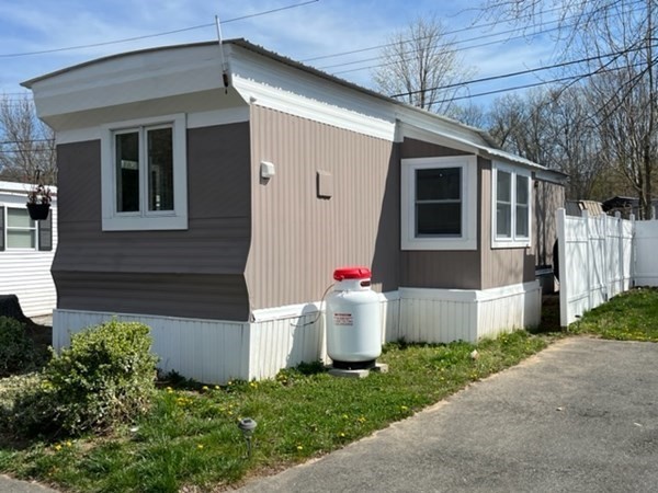 229 Miller Street, Unit C1 Ludlow, MA 01056 - Photo 2 of 19 a front view of a house with a yard