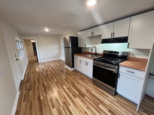 229 Miller Street, Unit C1 Ludlow, MA 01056 - Photo 5 of 19 a kitchen with granite countertop a stove and a refrigerator