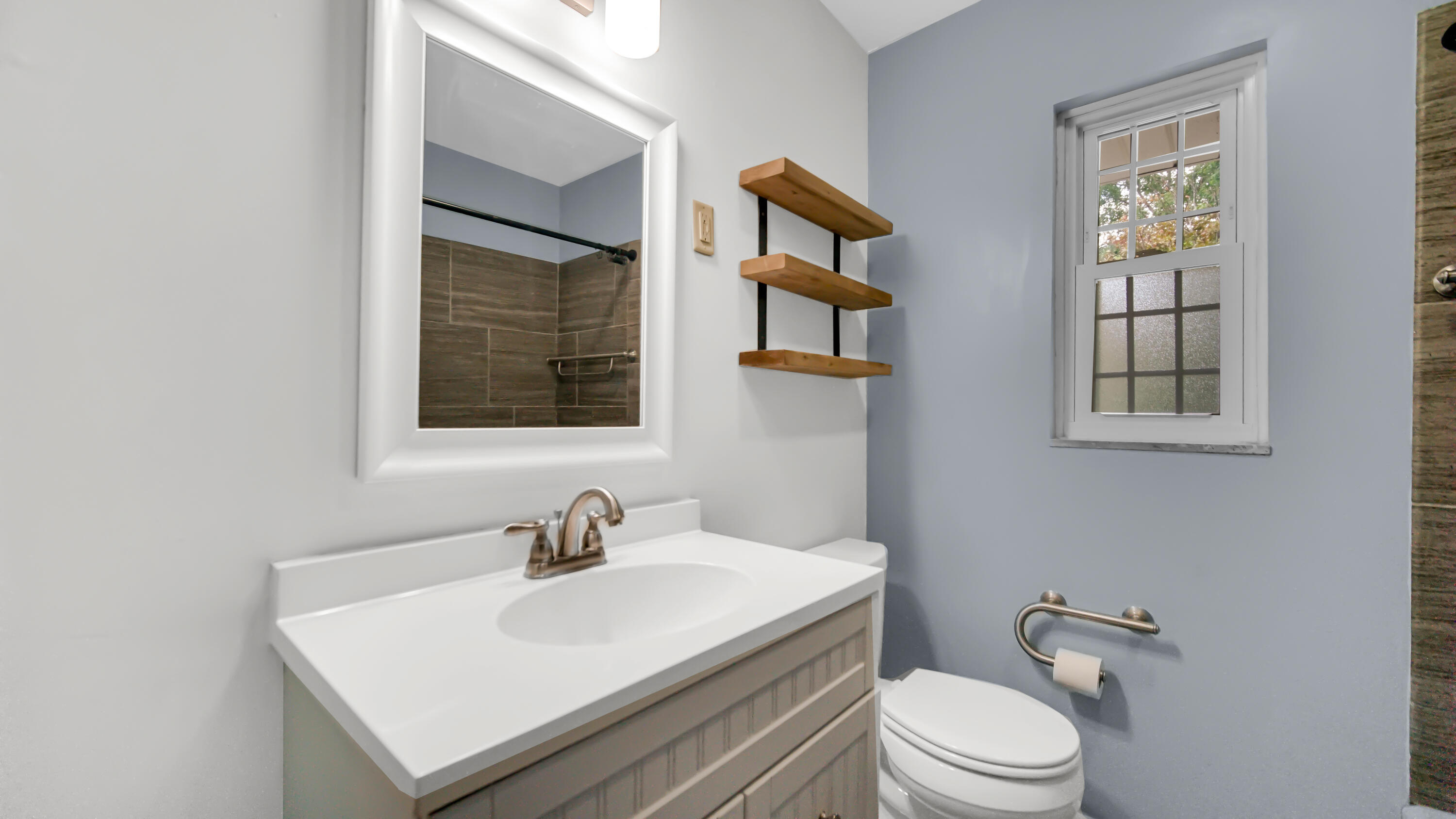 6957 Ash Avenue Gary, IN 46403 - Photo 11 of 22 a white toilet sitting next to a bathroom sink