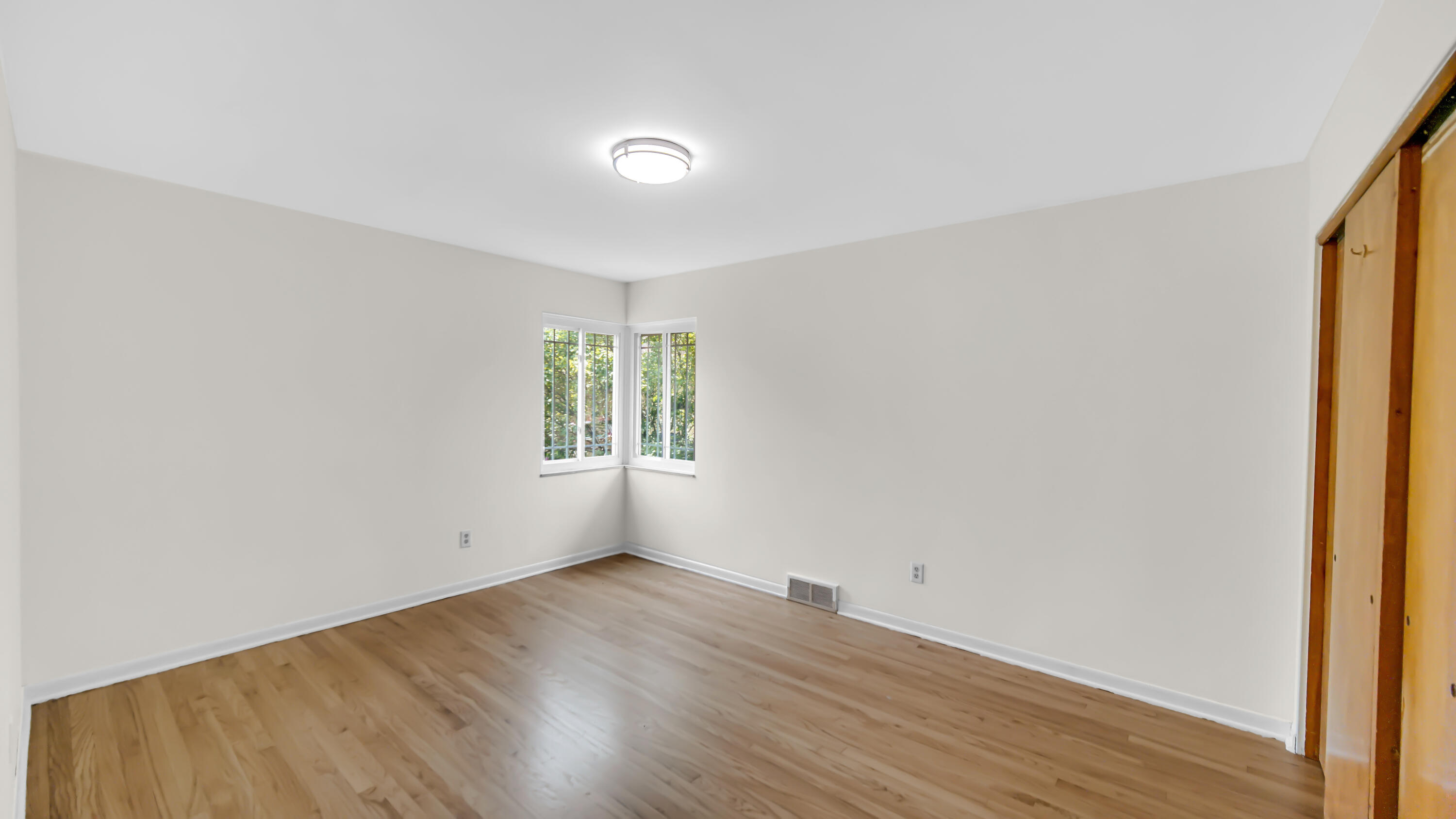 6957 Ash Avenue Gary, IN 46403 - Photo 15 of 22 an empty room with wooden floor and windows
