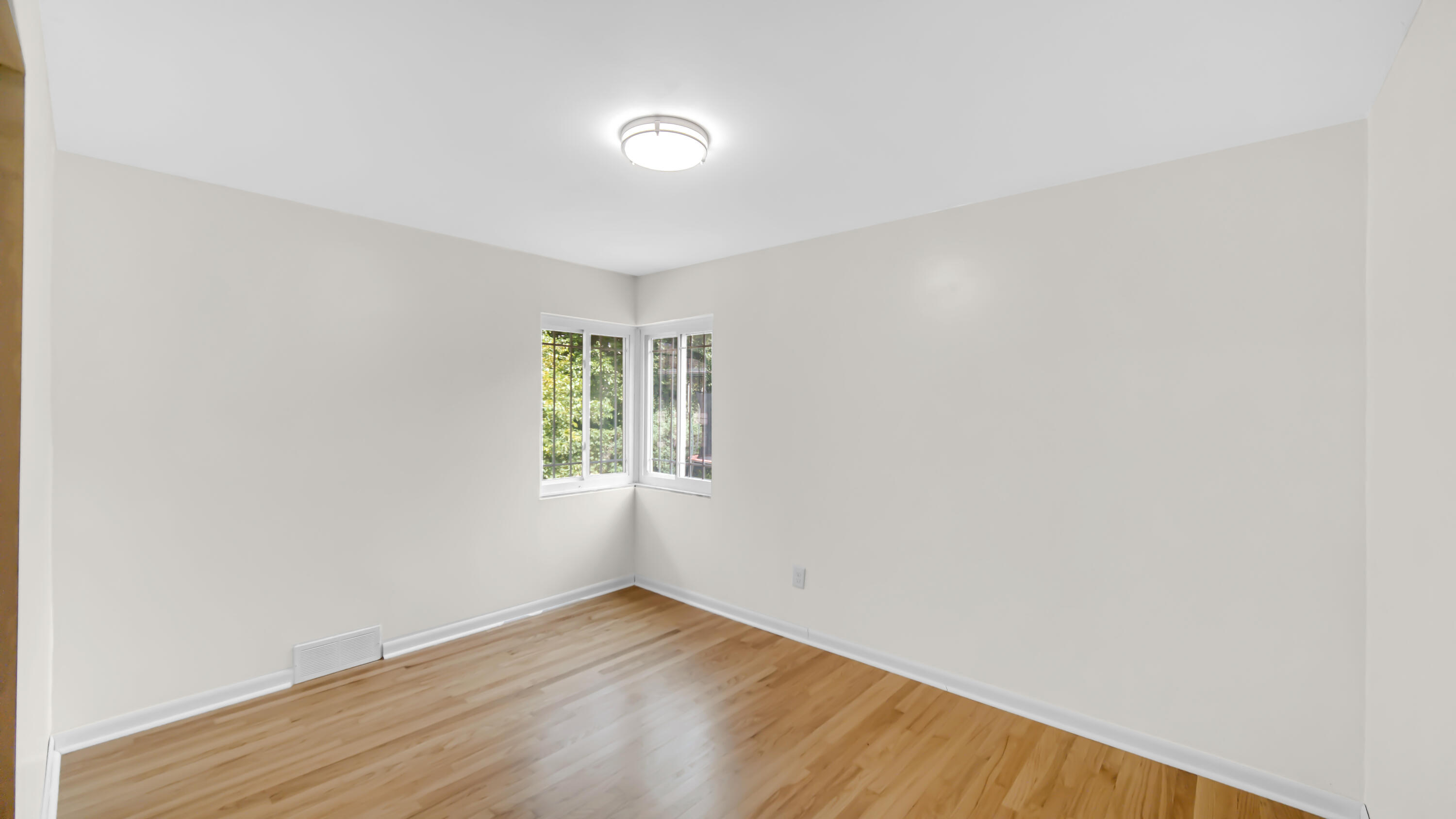 6957 Ash Avenue Gary, IN 46403 - Photo 16 of 22 an empty room with wooden floor and windows
