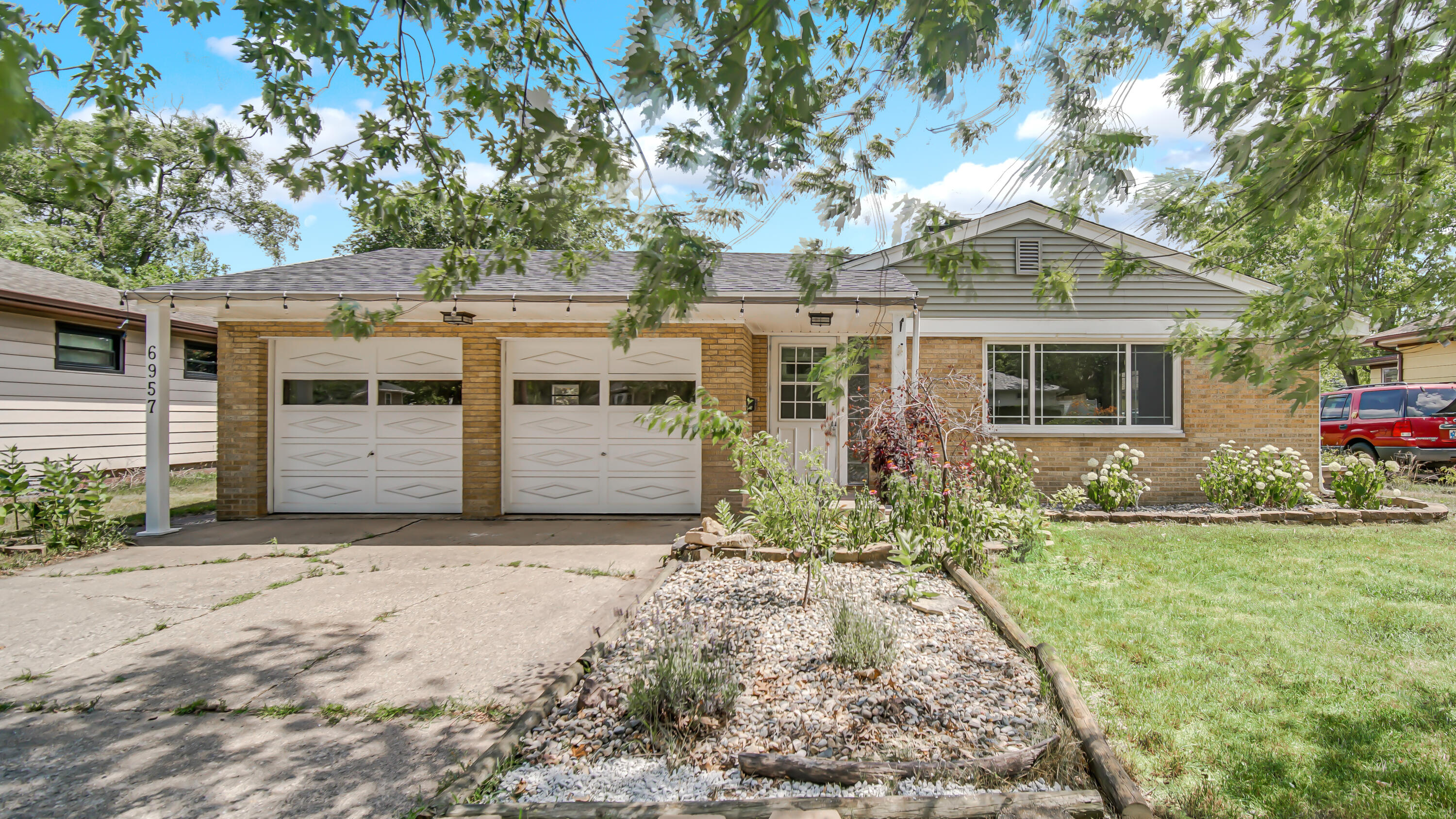 6957 Ash Avenue Gary, IN 46403 - Photo 2 of 22 a front view of a house with garden