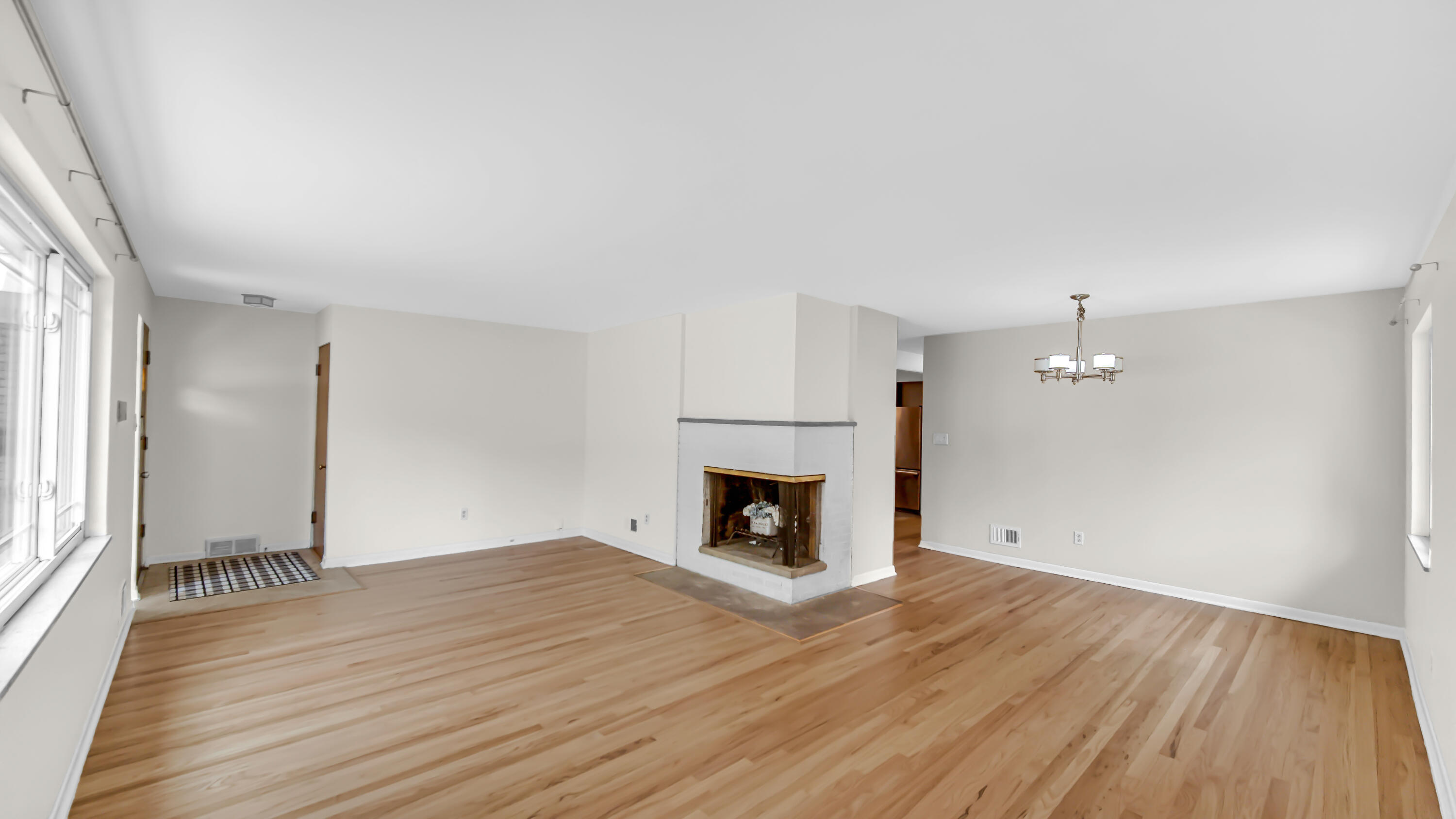 6957 Ash Avenue Gary, IN 46403 - Photo 4 of 22 an empty room with wooden floor and fireplace