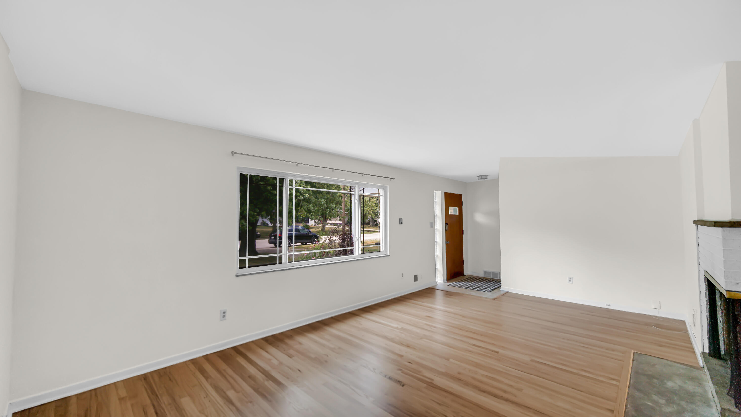 6957 Ash Avenue Gary, IN 46403 - Photo 5 of 22 an empty room with wooden floor and windows