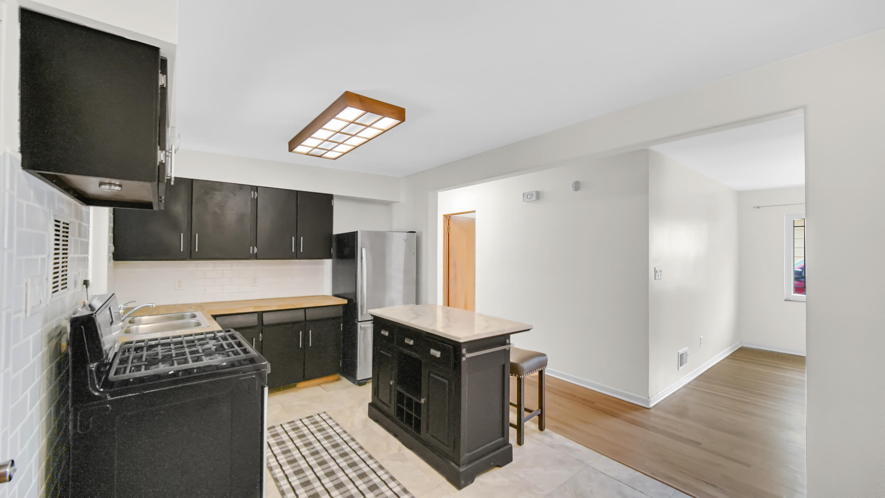 6957 Ash Avenue Gary, IN 46403 - Photo 8 of 22 a kitchen with stainless steel appliances a stove and a refrigerator