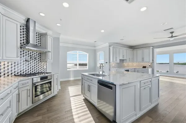 a kitchen with granite countertop white cabinets and white appliances
