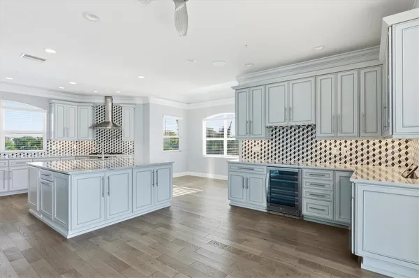 a view of a big room with wooden floor and windows