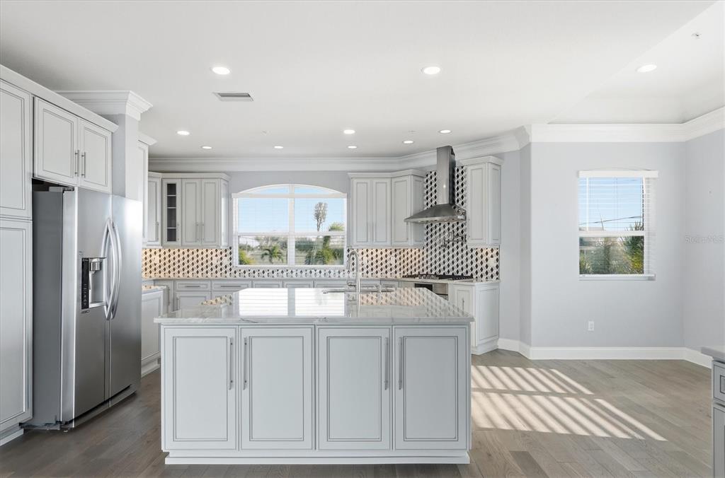 1910 Oregon Trail Englewood, FL 34224 - Photo 21 of 65 a kitchen with white cabinets and stainless steel appliances