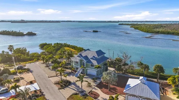 an aerial view of a houses with a lake view