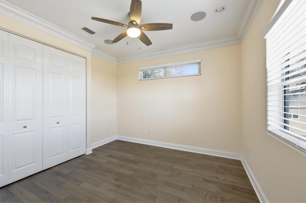 1910 Oregon Trail Englewood, FL 34224 - Photo 34 of 65 an empty room with wooden floor ceiling fan and windows