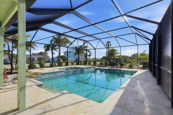 a view of a house with a yard and palm trees