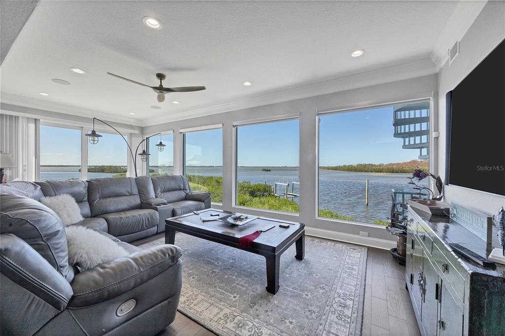 1910 Oregon Trail Englewood, FL 34224 - Photo 9 of 65 a living room with furniture a flat screen tv and a floor to ceiling window