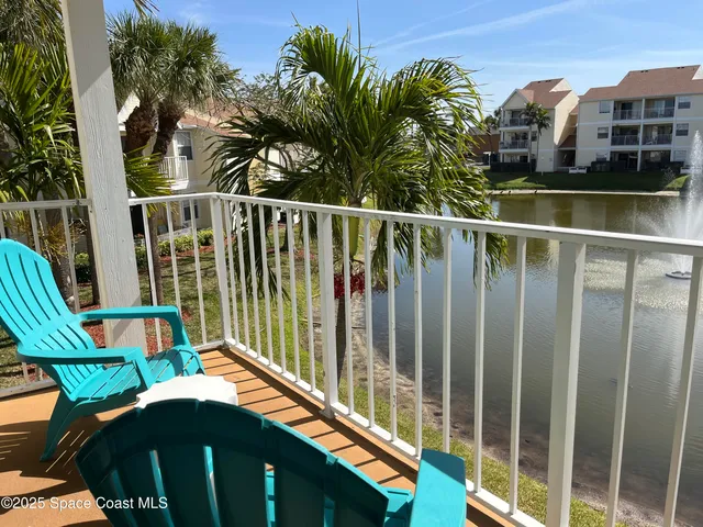 a view of balcony with two chairs and a table