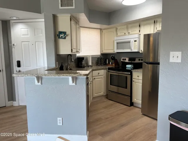 a kitchen with stainless steel appliances a stove sink and refrigerator