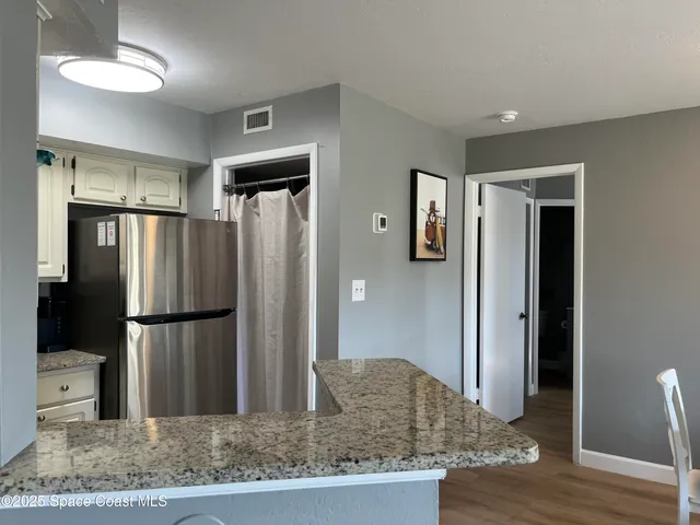a kitchen with stainless steel appliances granite countertop a refrigerator and a granite counter tops