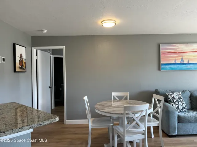 a view of a dining room with furniture and window