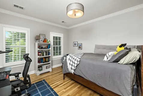 a bedroom with furniture and a book shelf