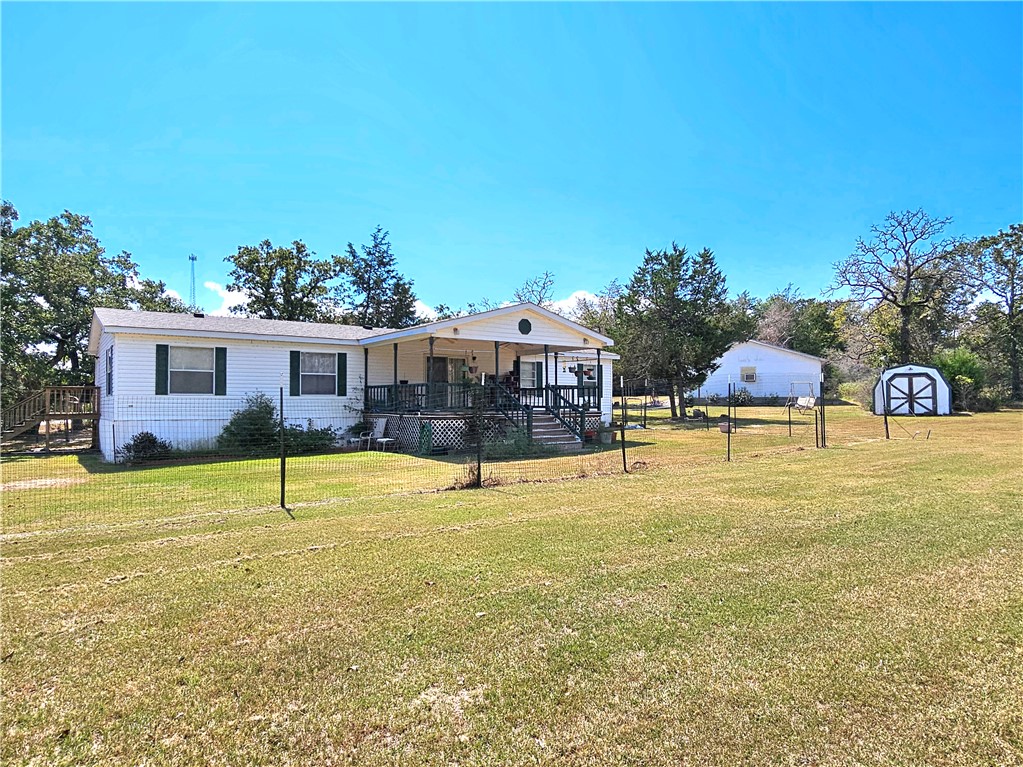 a swimming pool with outdoor seating and yard