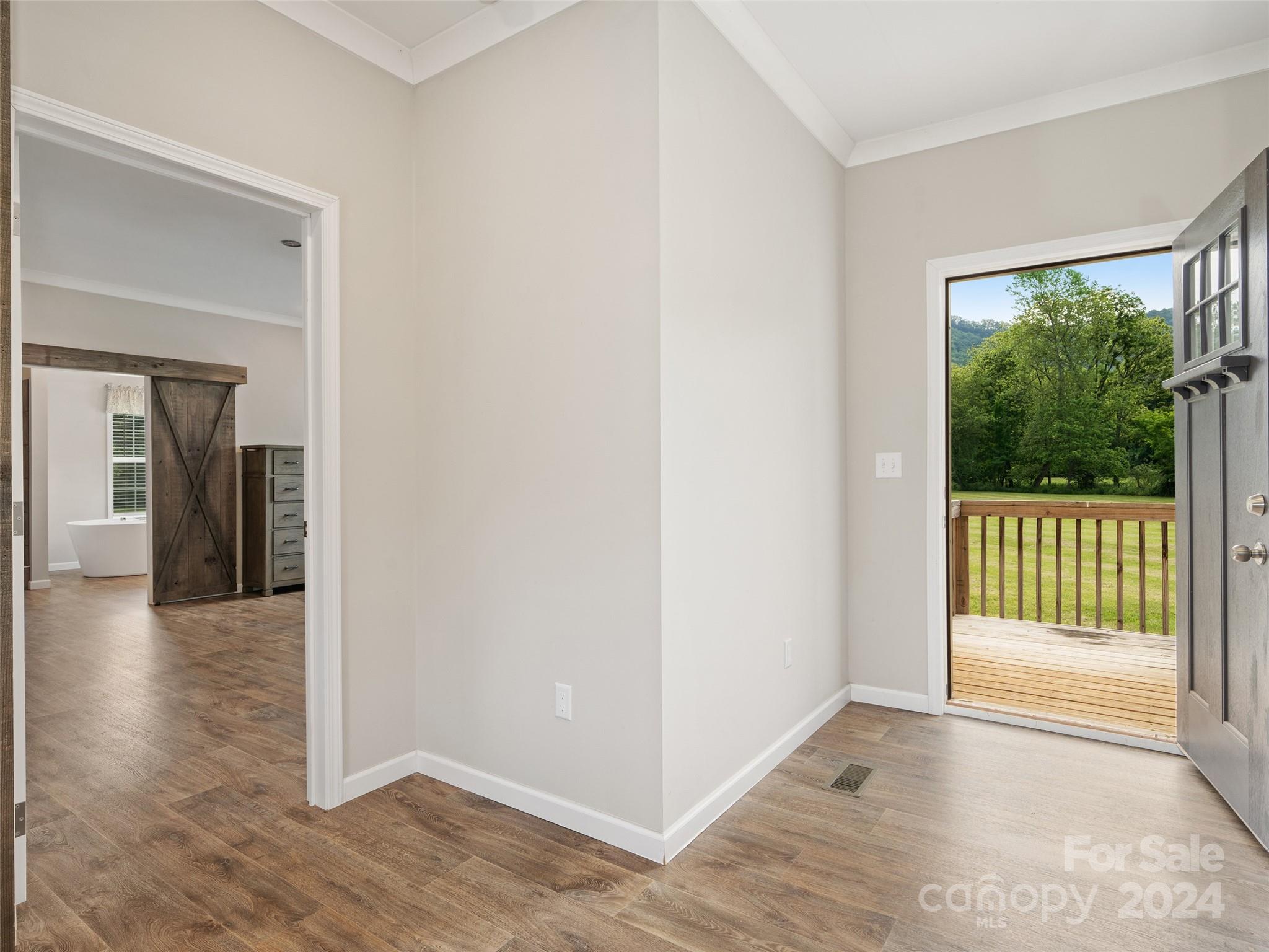 1629 Lake Logan Road Canton, NC 28716 - Photo 4 of 26 a view of a hallway with wooden floor and glass door