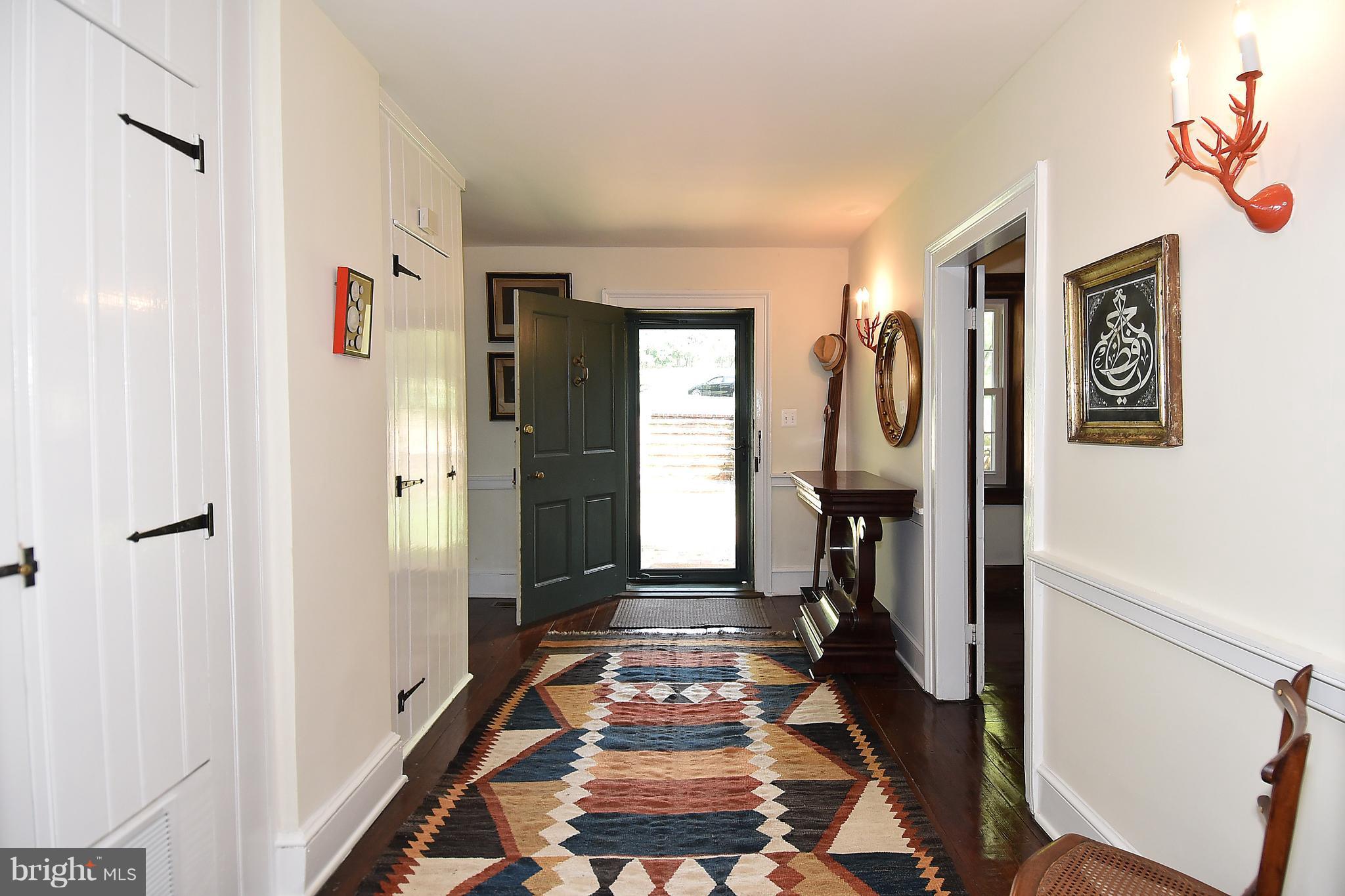 20046 St Louis Road Purcellville, VA 20132 - Photo 2 of 30 a view of a hallway with wooden floor and windows