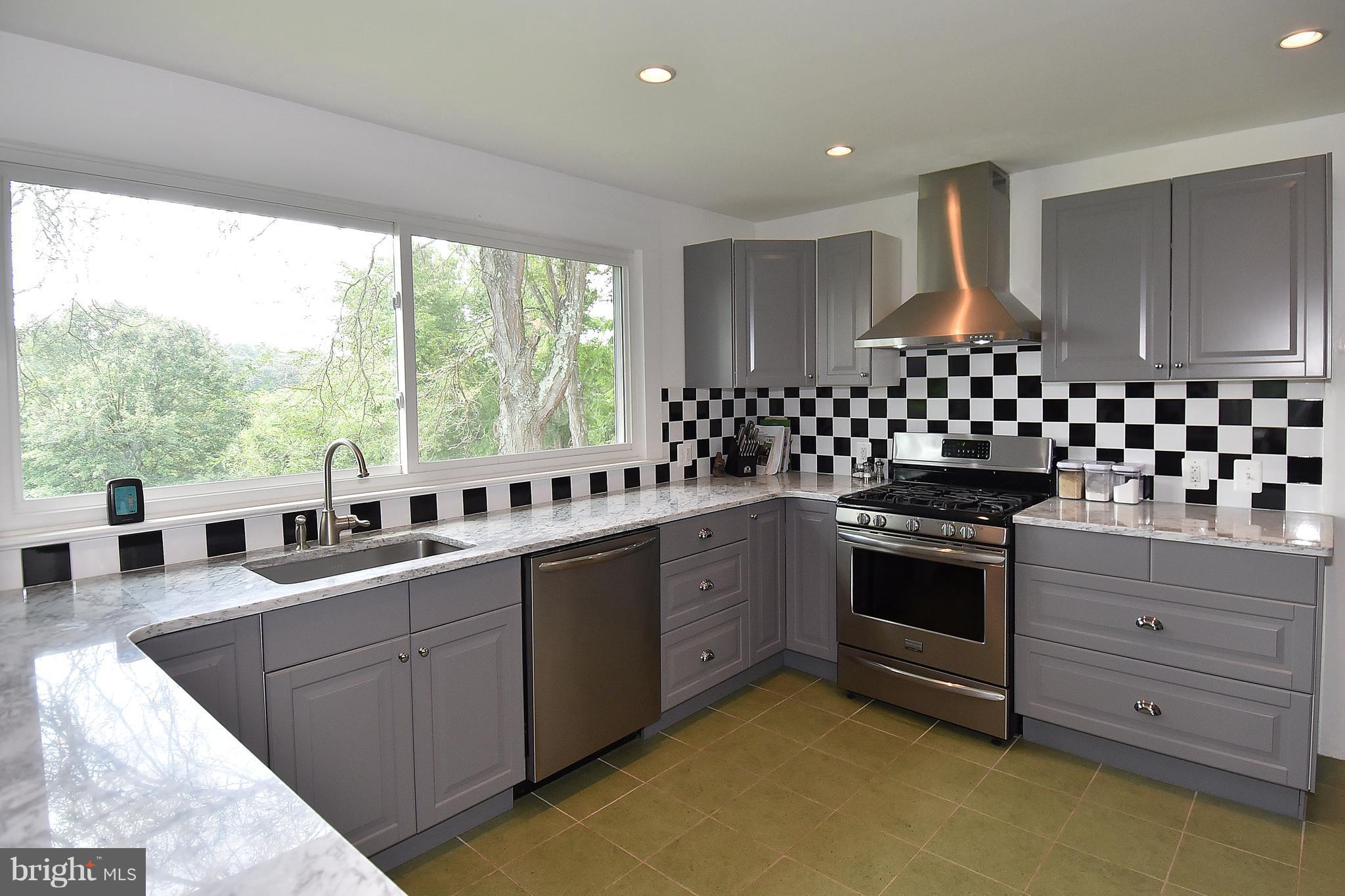 20046 St Louis Road Purcellville, VA 20132 - Photo 11 of 30 a kitchen with lots of counter top space sink and stove