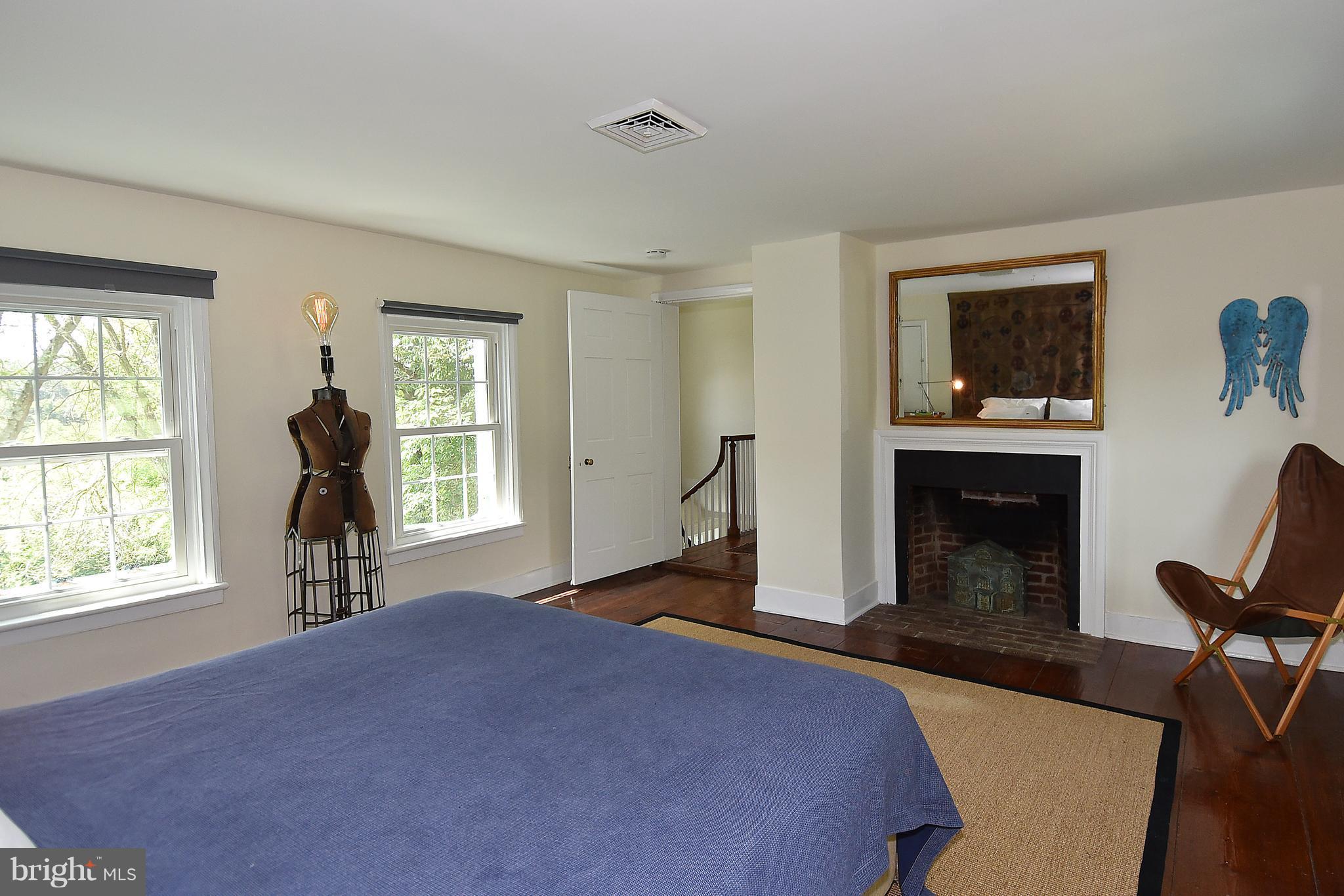 20046 St Louis Road Purcellville, VA 20132 - Photo 17 of 30 a bedroom with a bed and a fireplace