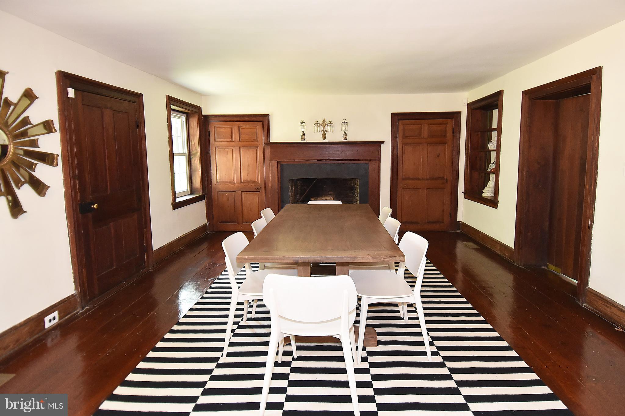 20046 St Louis Road Purcellville, VA 20132 - Photo 3 of 30 a view of a dining room with furniture a rug and wooden floor