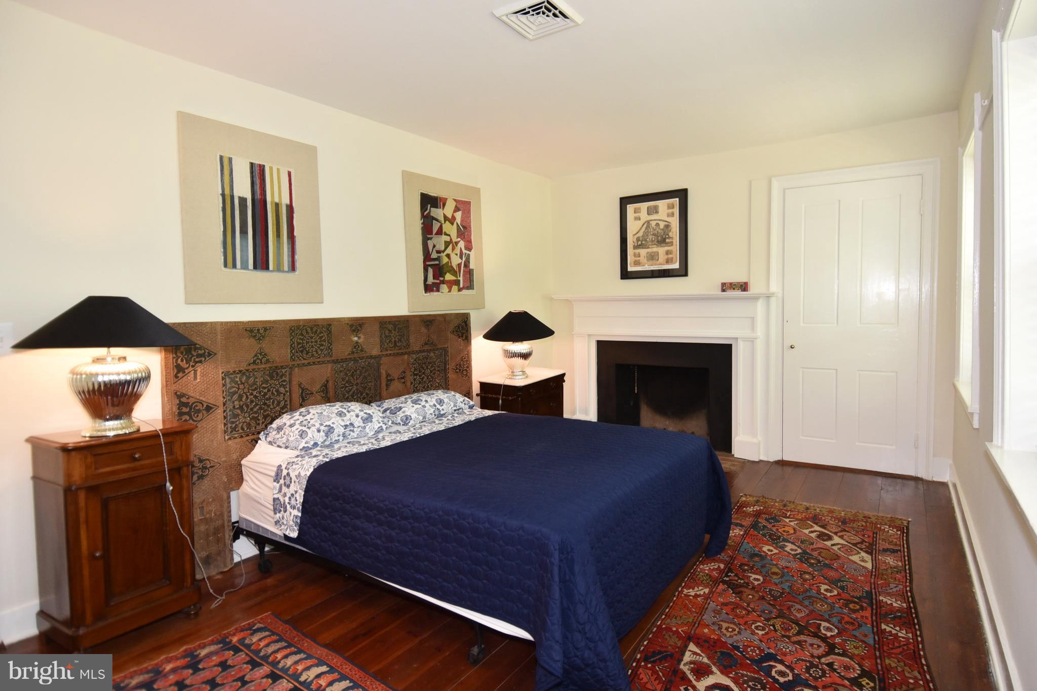 20046 St Louis Road Purcellville, VA 20132 - Photo 21 of 30 a bedroom with a bed and wooden floor