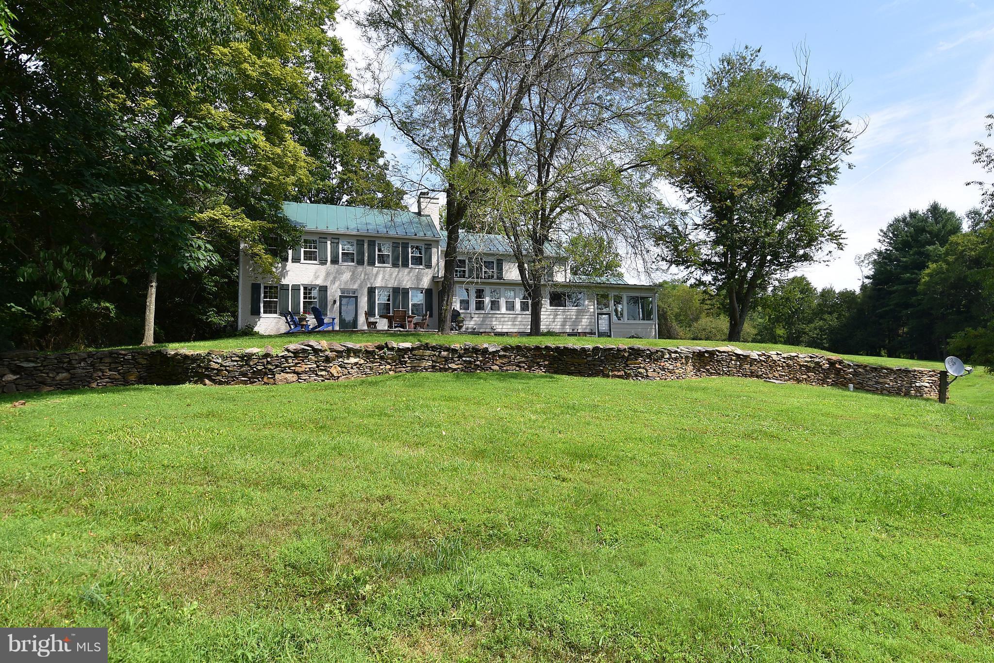 20046 St Louis Road Purcellville, VA 20132 - Photo 29 of 30 a view of a house with a big yard and palm trees