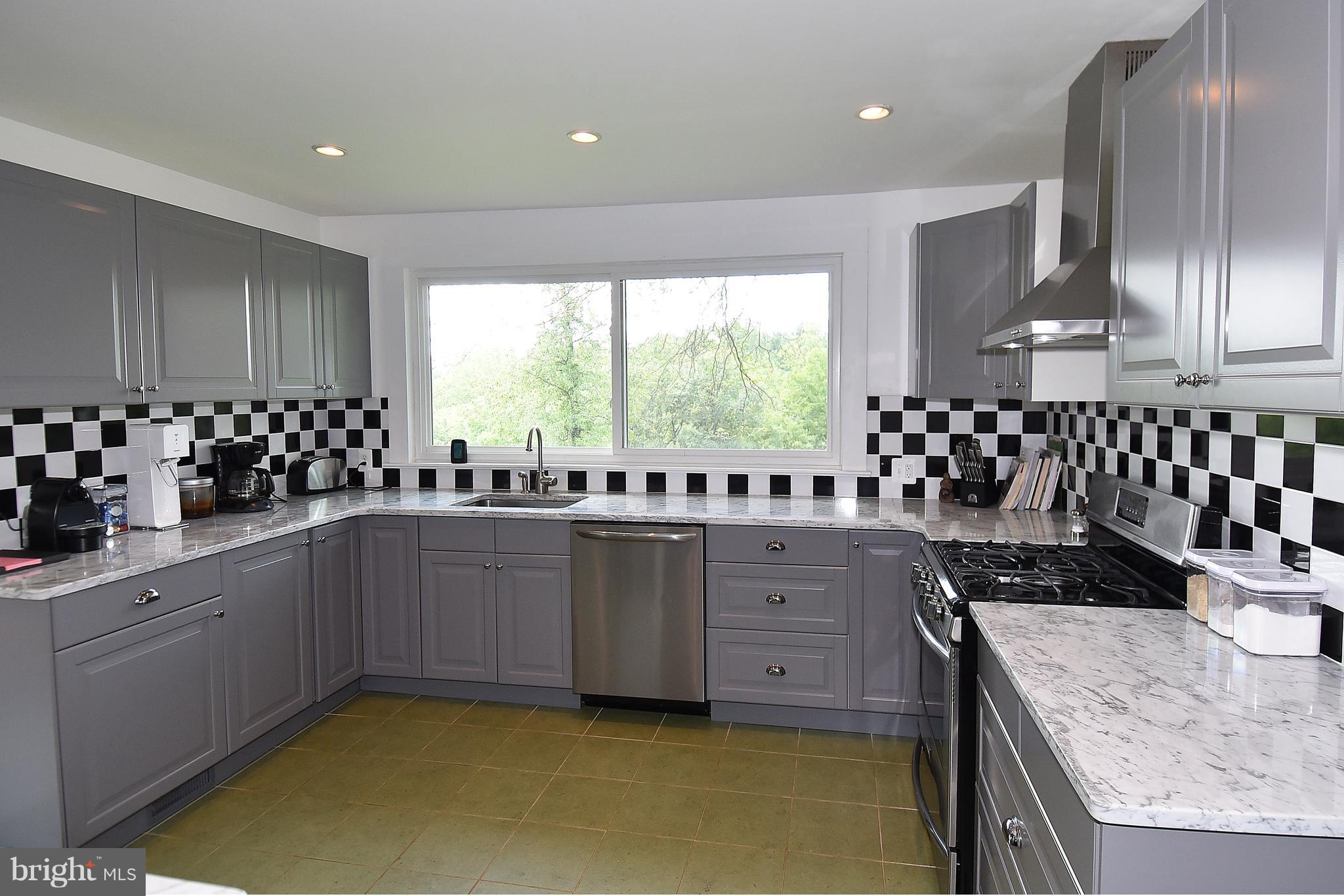 20046 St Louis Road Purcellville, VA 20132 - Photo 10 of 30 a kitchen with a sink a window and cabinets