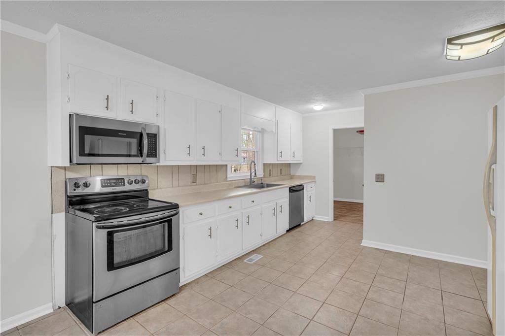 32 Cox Road Southeast Cartersville, GA 30121 - Photo 12 of 60 a kitchen with granite countertop white cabinets stainless steel appliances and a sink