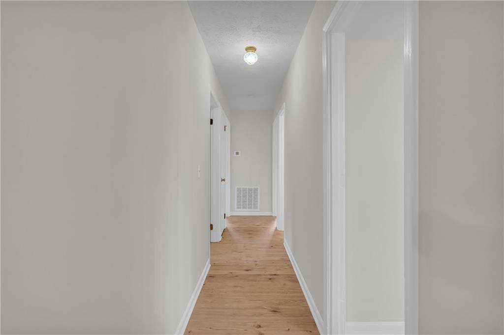 32 Cox Road Southeast Cartersville, GA 30121 - Photo 21 of 60 a view of a hallway with wooden floor