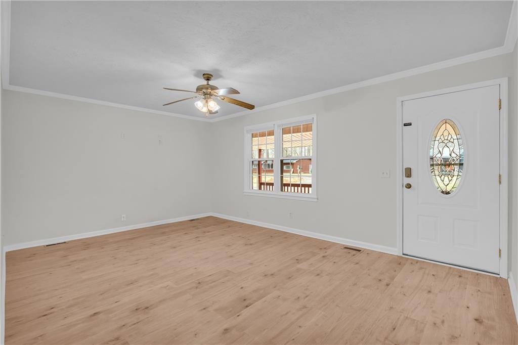 32 Cox Road Southeast Cartersville, GA 30121 - Photo 7 of 60 an empty room with windows and chandelier fan