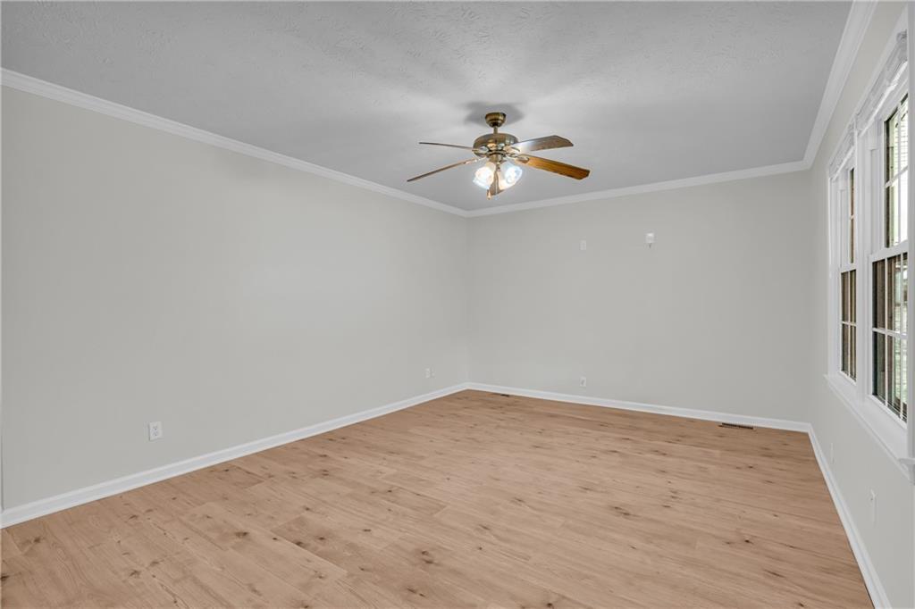 32 Cox Road Southeast Cartersville, GA 30121 - Photo 8 of 60 wooden floor in an empty room with a window