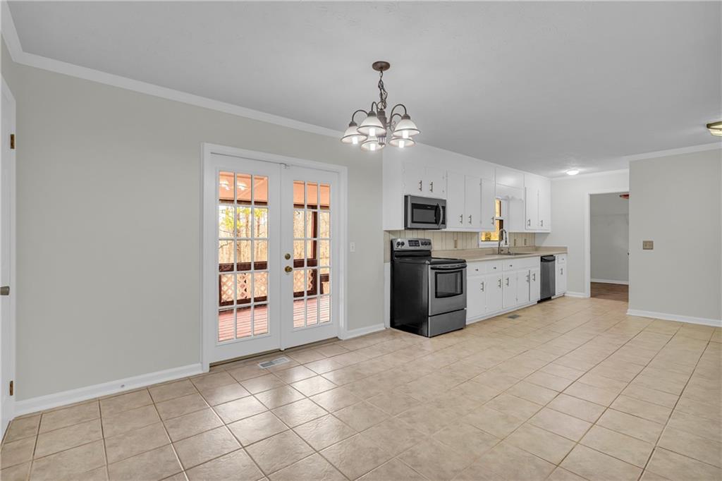 32 Cox Road Southeast Cartersville, GA 30121 - Photo 10 of 60 a large white kitchen with a stove top oven a cabinetry and kitchen view