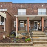 front view of a brick house with a large windows