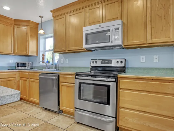 a kitchen with stainless steel appliances granite countertop a stove microwave and cabinets