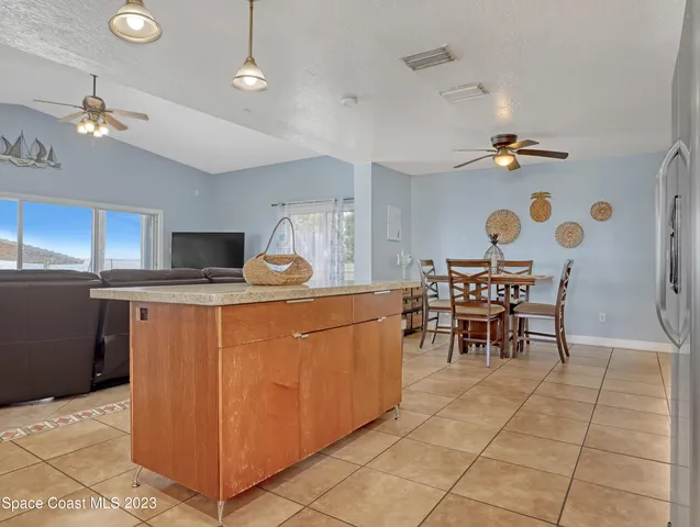 a kitchen with stainless steel appliances kitchen island granite countertop a sink a counter top space and cabinets