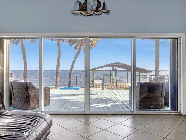a living room with a large window and a table