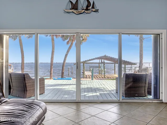 a living room with a large window and a table