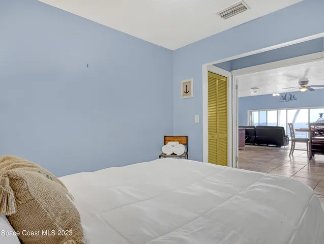 a bed room with a bed and a large window