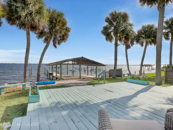 a view of a house with swimming pool and sitting area